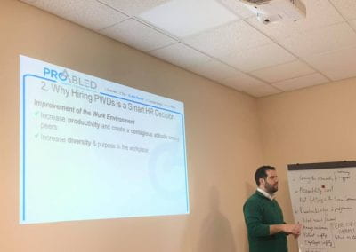 Samer Sfeir facilitating the workshop, slide about why hiring PWDs